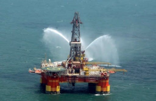 Iran's offshore oil platform in the Caspian Sea. The United States has exempted China and Singapore from sanctions over purchases of oil from Iran hours before a deadline, saying that major economies were united in pressuring Tehran