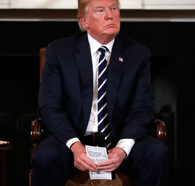 US President Donald Trump holds notes while speaking with victims of gun violence at the White House. Source: AAP