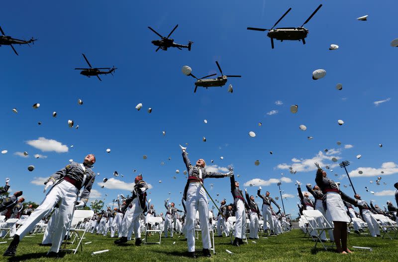 West Point graduating cadets throw hats in the air in celebration as U.S. Army helicopters fly overhead at 2020 United States Military Academy Graduation Ceremony at West Point, New York