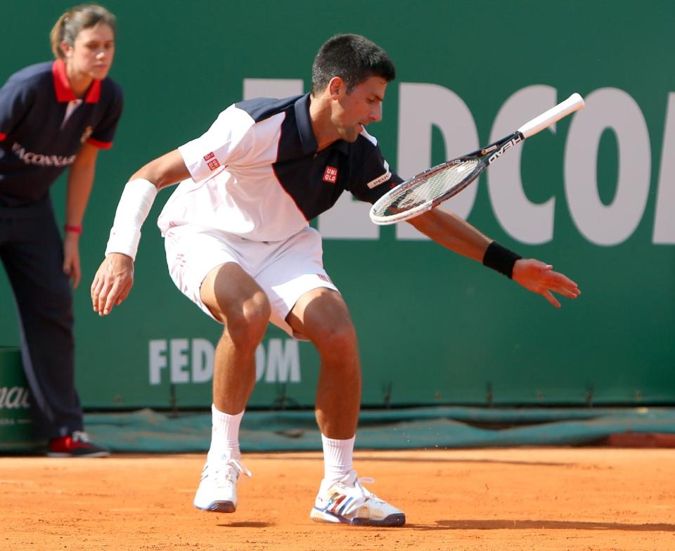 Novak Djokovic of Serbia loses his racket during their semifinal match of the Monte Carlo Tennis Masters tournament against Roger Federer of Switzerland, in Monaco, Saturday, April, 19, 2014. Federer won 7-6, 6-2. (AP Photo/Claude Paris)