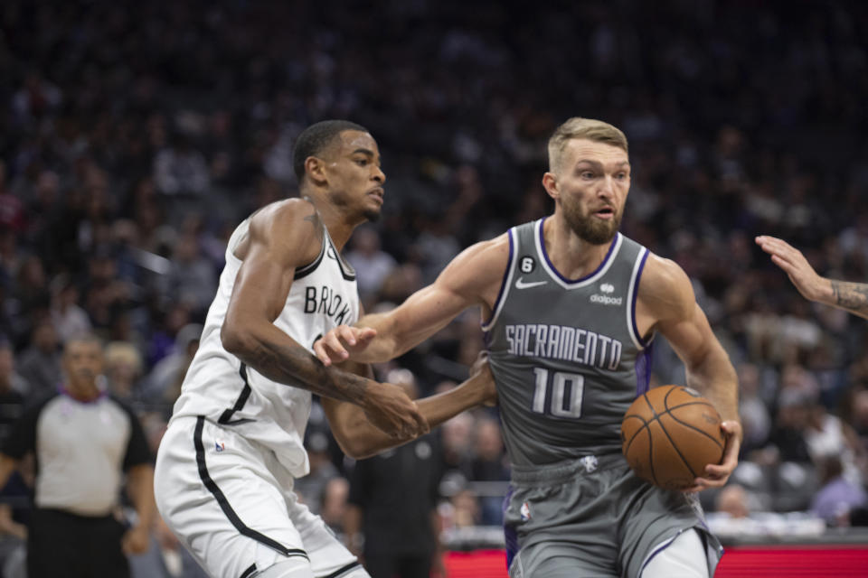 Sacramento Kings forward Domantas Sabonis (10) is defended by Brooklyn Nets forward Nic Claxton (33) during the second half of an NBA basketball game in Sacramento, Calif., Tuesday, Nov. 15, 2022. The Kings won 153-121. (AP Photo/José Luis Villegas)