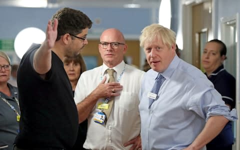 Omar Salem, whose daughter is being treated, in the Acorn children's ward, gestures as he talks to Britain's Prime Minister Boris Johnson  - Credit: Yui Mok&nbsp;/PA Pool