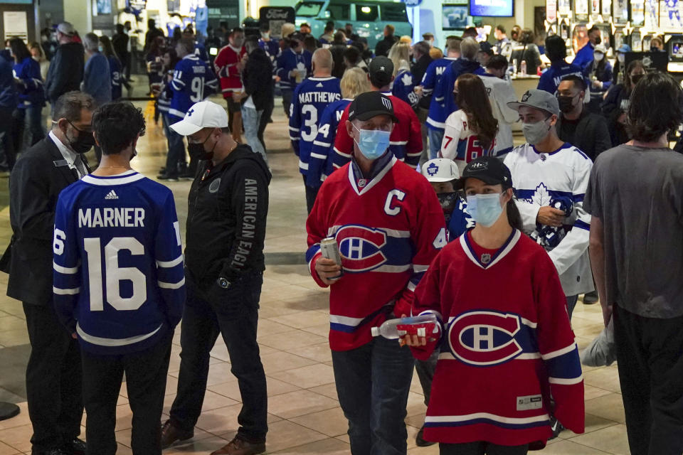 Fans walk through the arena concourse before the Toronto Maple Leafs' home-opener NHL hockey game against the Montreal Canadiens in Toronto on Wednesday, Oct. 13, 2021. (Evan Buhler/The Canadian Press via AP)