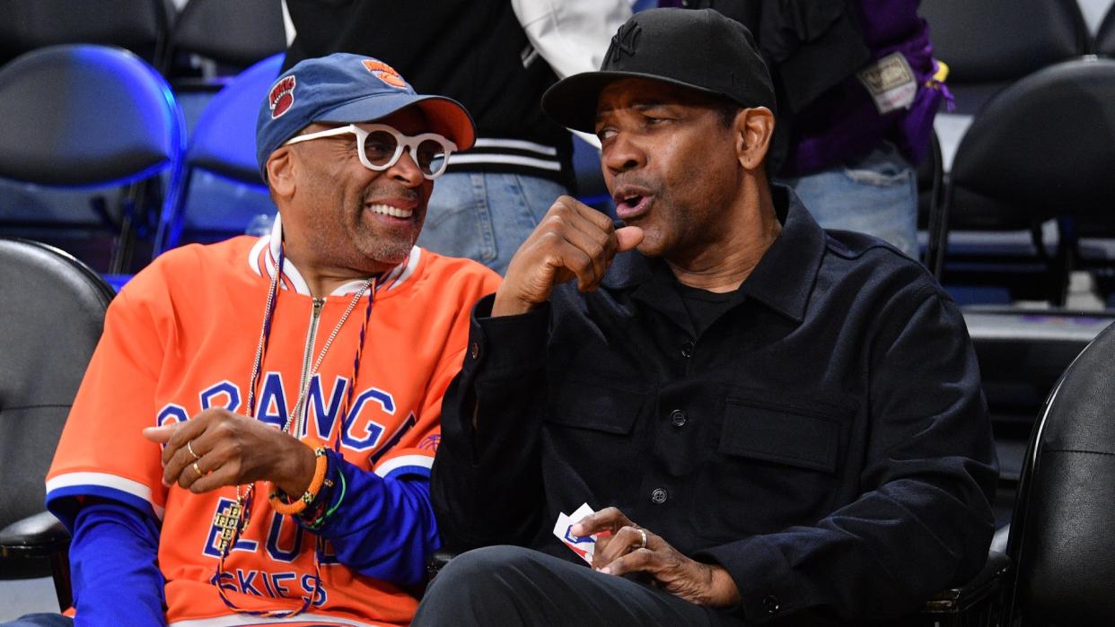  Spike Lee and Denzel Washington watching a basketball game. 