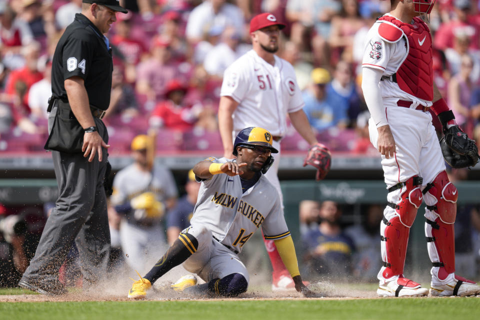 Milwaukee Brewers' Andruw Monasterio (14) scores on a single by Blake Perkins in the second inning of a baseball game against the Cincinnati Reds in Cincinnati, Saturday, June 3, 2023. (AP Photo/Jeff Dean)