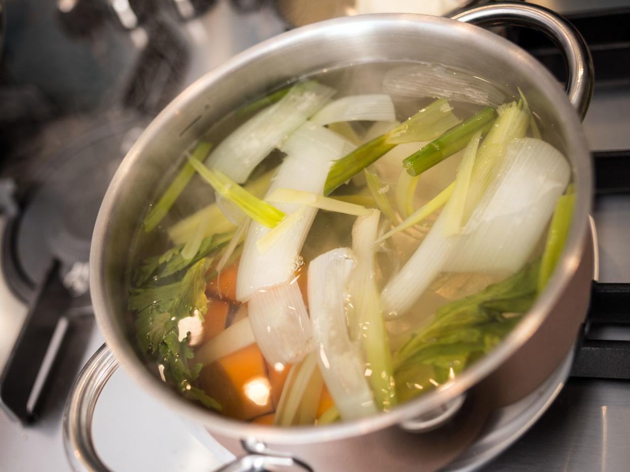 Professional chef preparing meal in private house: Vegetable soup broth