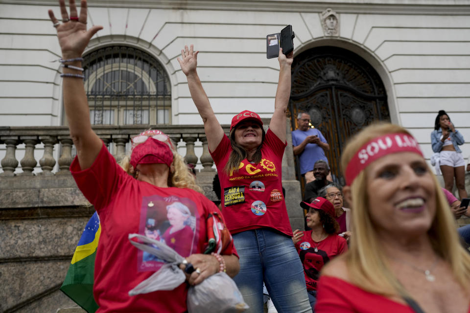 Followers of former Brazilian President Luiz Inacio "Lula" da Silva, who is running for president again, celebrate partial results after general election polls closed in Rio de Janeiro, Brazil, Sunday, Oct. 2, 2022. (AP Photo/Silvia Izquierdo)