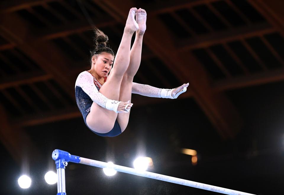 Sunisa Lee hovers above the uneven bars.