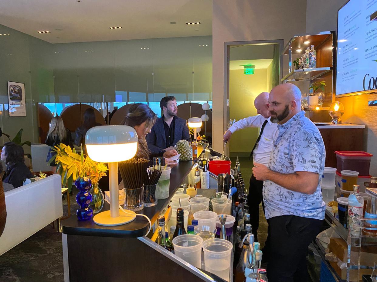 Inside the Mile High Club lounge as guests order cocktails from bartenders. The pop-up is a new collaboration between Vast and Wanderfolk Spirits.