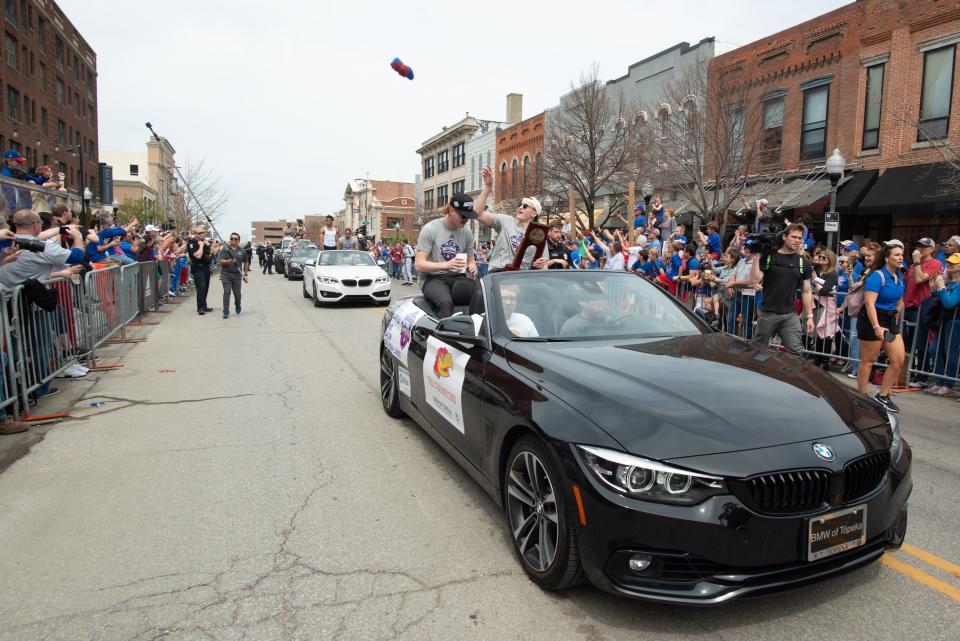 Kansas players Mitch Lightfoot and Chris Teahan  throw shirts from their ride at Sunday's NCAA Championship parade in downtown Lawrence.