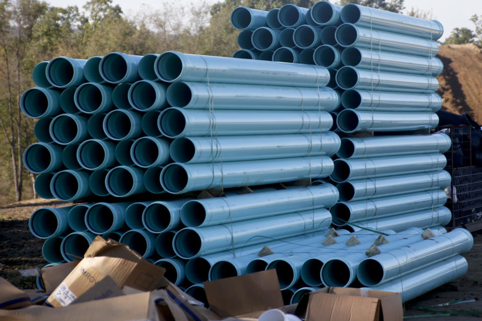 FILE - Drainage pipe is stacked at a construction site for a housing development on Oct. 19, 2017 in Jackson Township, outside Zelienople, Pa. (AP Photo/Keith Srakocic, File)