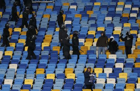 Football Soccer - FC Dynamo Kyiv v Besiktas - UEFA Champions League Group Stage - Group B - NSC Olimpiyskiy Stadium, Kiev, Ukraine - 6/12/16. Police officers with Besiktas' fans during the match. REUTERS/Gleb Garanich