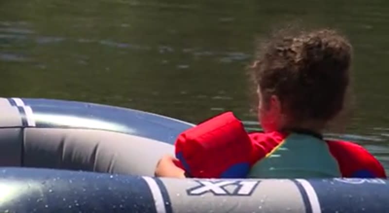 A child in a small boat with a life jacket on the Sandy River, May 11, 2024 (KOIN)