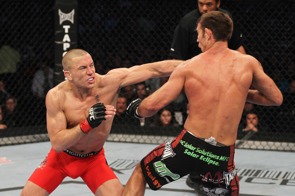 Georges St-Pierre (L) and Jake Shields exchange blows during their welterweight championship bout at UFC 129 in the Rogers Centre on April 30, 2011, in Toronto. (Getty Images)