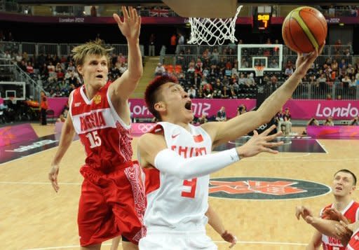 Russian forward Andrei Kirilenko (left) vies with Chinese forward Sun Yue during the men's preliminary round group B basketball match of the London 2012 Olympic Games at the basketball arena in London. Kirilenko and Alexey Shved, future NBA teammates for the Minnesota Timberwolves, powered a veteran Russian side over China 73-54 to stay unbeaten in Olympic round-robin play