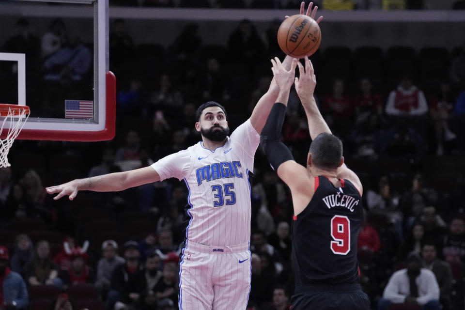 Orlando Magic center Goga Bitadze, left, blocks a shot by Chicago Bulls center Nikola Vucevic (9) during the first half of an NBA basketball game in Chicago, Friday, Nov. 17, 2023. (AP Photo/Nam Y. Huh)