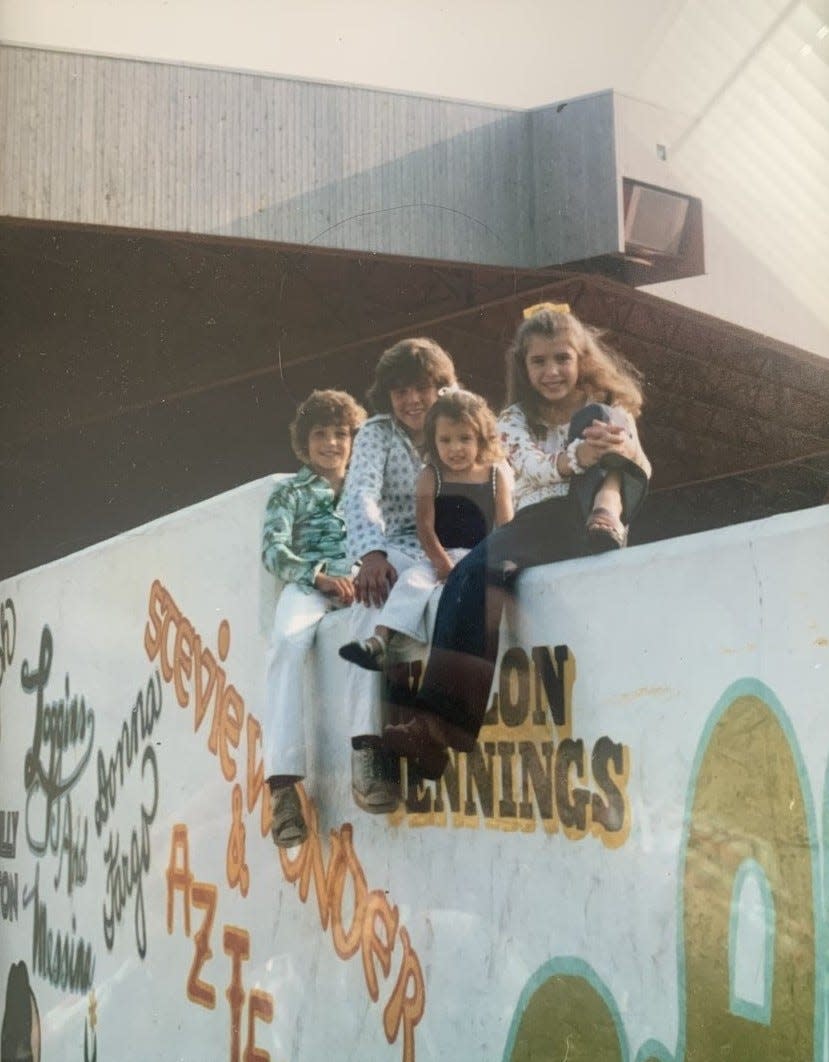 Builder Joe Locricchio's children sit atop the Pine Knob entrance wall in the '70s.