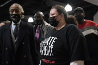 Katie Wright, mother of Daunte Wright, leaves Shiloh Temple International Ministries during her son's wake alongside Rev. Al Sharpton, left, and attorney Ben Crump, center left, Wednesday, April 21, 2021, in Minneapolis. The 20-year-old Wright was killed by then-Brooklyn Center police officer Kim Potter during a traffic stop. (AP Photo/John Minchillo)