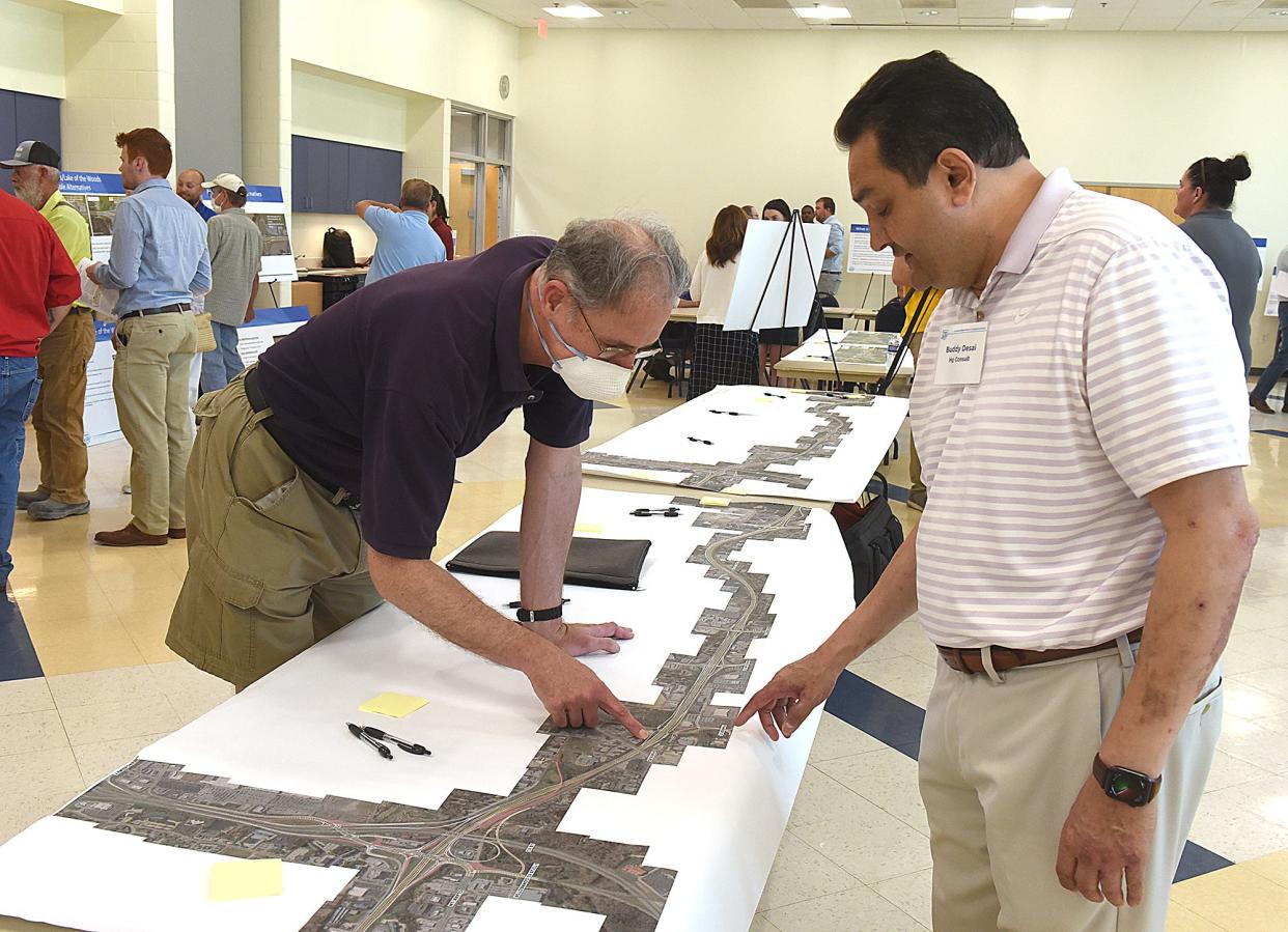 Buddy Desal, right, of HG Consult Inc., St. Louis, a consulting engineering firm, explains to Bruce Alspaugh, of Columbia, the proposed Alternative 2 plan of Stadium Boulevard to the 70/63 interchange on Thursday at the MODOT open house held at the Activity and Recreation Center.