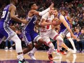 Mar 17, 2019; Sacramento, CA, USA; Chicago Bulls guard Zach LaVine (8) drives in between Sacramento Kings guard Buddy Hield (24) and forward Nemanja Bjelica (88) during the third quarter at Golden 1 Center. Mandatory Credit: Kelley L Cox-USA TODAY Sports