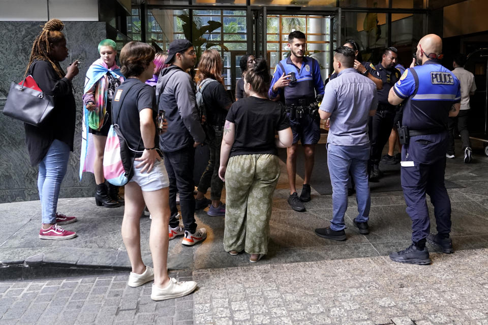 People with the group Women's Voices of SW Florida gather outside of the Four Seasons Hotel where Florida Gov. Ron DeSantis is expected to meet with donors, Thursday, May 25, 2023, in Miami. The group is a black and queer-led organization dedicated to defending human rights and reproductive freedoms. De Santis launched his 2024 presidential campaign Wednesday. (AP Photo/Lynne Sladky)