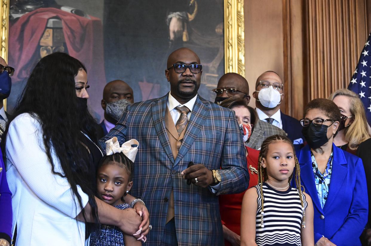 Philonise Floyd, the brother of George Floyd, center, speaks next to Gianna Floyd, George Floyd's daughter, second left, while while standing with members of the Floyd family prior to a meeting to mark the anniversary of the death of George Floyd with House Speaker Nancy Pelosi on May 25, at the Capitol.