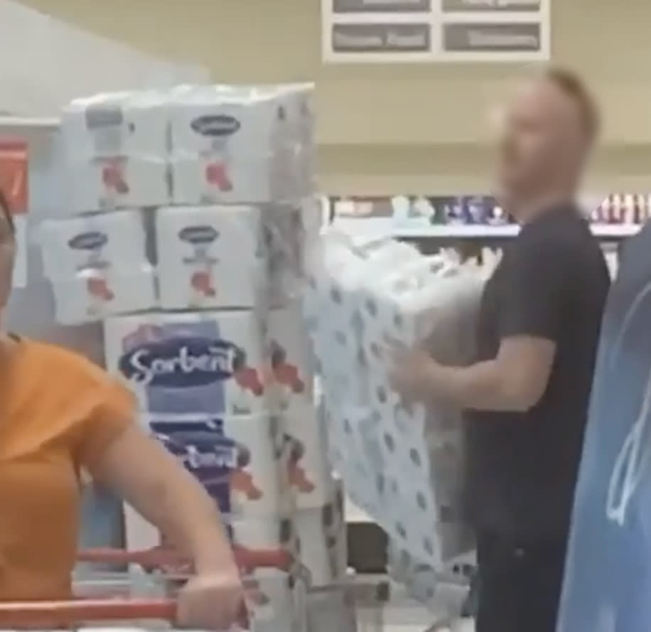 Adelaide Coles shopper piles trolley with toilet paper.