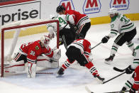 Chicago Blackhawks goaltender Kevin Lankinen (32) stops the shot of Dallas Stars center Justin Dowling (37) during the second period of an NHL hockey game Tuesday, April 6, 2021, in Chicago. (AP Photo/Jeff Haynes)