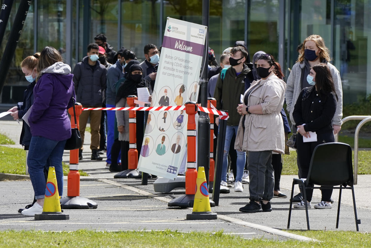 People queuing for Covid vaccinations at the ESSA academy in Bolton as the spread of the Indian coronavirus variant could lead to the return of local lockdowns, ministers have acknowledged. Bolton, Blackburn with Darwen and Bedford are the areas ministers are most concerned about. Picture date: Tuesday May 18, 2021. (Photo by Danny Lawson/PA Images via Getty Images)