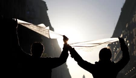 People hold scarves, symbol of the human rights organization Madres de Plaza de Mayo (Mothers of the disappeared), during a demonstration against the Supreme Court decision to reduce detention time for crimes against humanity committed during Argentina's last military dictatorship, in Buenos Aires, Argentina, May 10, 2017. REUTERS/Martin Acosta