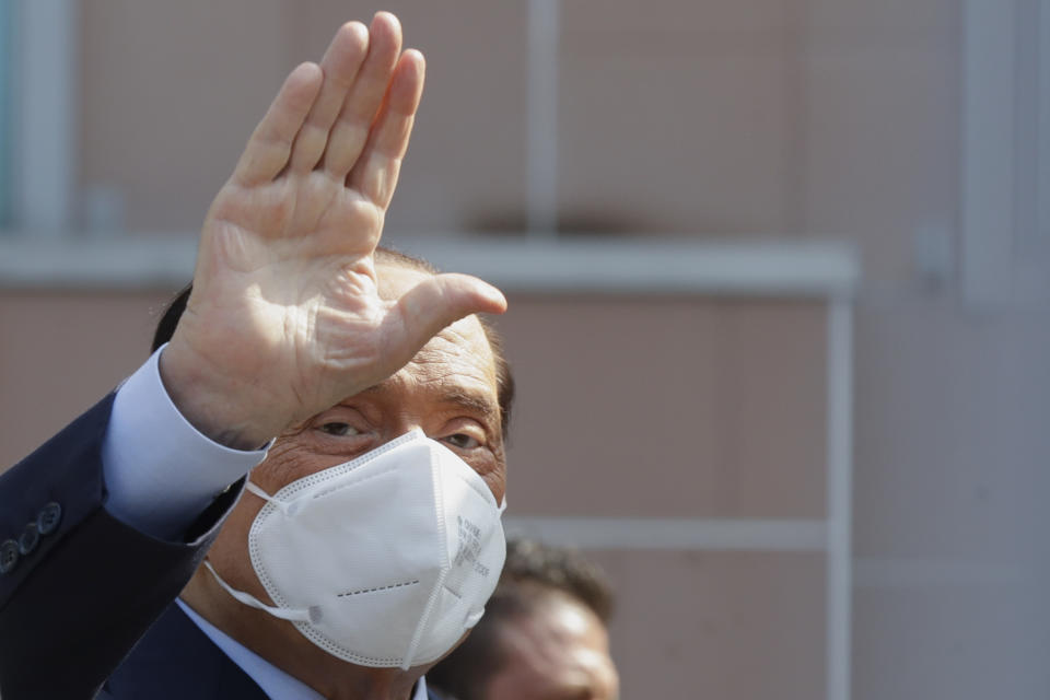 Italian former Premier Silvio Berlusconi waves as he leaves the San Raffaele hospital in Milan, Italy, Monday, Sept. 14, 2020. Berlusconi had been hospitalized as a precaution to monitor his coronavirus infection after testing positive for COVID-19. (AP Photo/Luca Bruno)