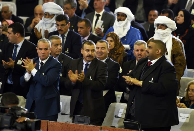 Algerian parliamentary group leaders applaud during a vote on a package of constitutional reforms in the capital Algiers on February 7, 2016