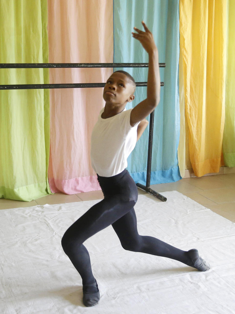 FILE - Ballet dancer Anthony Mmesoma Madu rehearses in Lagos, Nigeria on Aug. 18, 2020. The 11-year-old gained fame through a simple cellphone video of him performing the pirouette without shoes in the drizzling rain in Nigeria earlier this year. By the end of August, the video garnered more than 20 million views on social media including by actor Cynthia Erivo, who decided to sponsor Madu's training and helped bring the video to the attention of the New York-based American Ballet Theater, who offered him a scholarship. (AP Photo/Sunday Alamba, File)