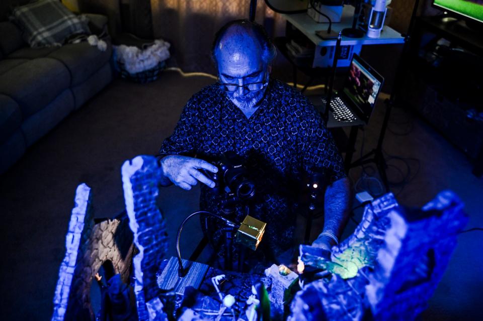 Kevin Epling takes photographs of one of his toy photography art sets on Wednesday, May 24, 2023, at his home in East Lansing.