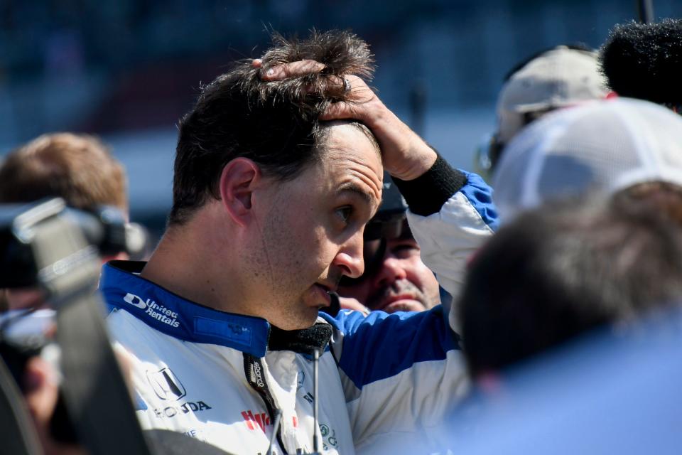 Rahal Letterman Lanigan Racing driver Graham Rahal (15) takes off his helmet after getting bumped from the race by teammate Rahal Letterman Lanigan Racing driver Jack Harvey (30) on Sunday, May 21, 2023, during the second day of qualifying ahead of the 107th running of the Indianapolis 500 at Indianapolis Motor Speedway. 