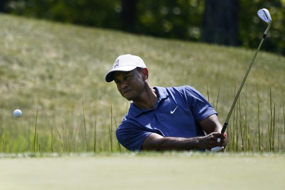 Tiger Woods makes his first attempted shot out of a trap on the fourteenth tee during the third round of the Northern Trust golf tournament at TPC Boston, Saturday, Aug. 22, 2020, in Norton, Mass. (AP Photo/Charles Krupa)