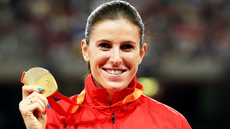Zuzana Hejnova (pictured) smiling as she holds the Olympic gold medal.