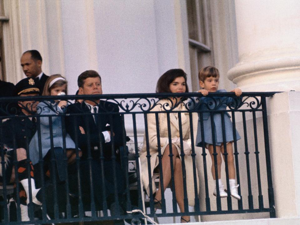 John F. Kennedy, Jackie Kennedy, and their two children and their two children, Caroline and John, Jr., watch from the balcony