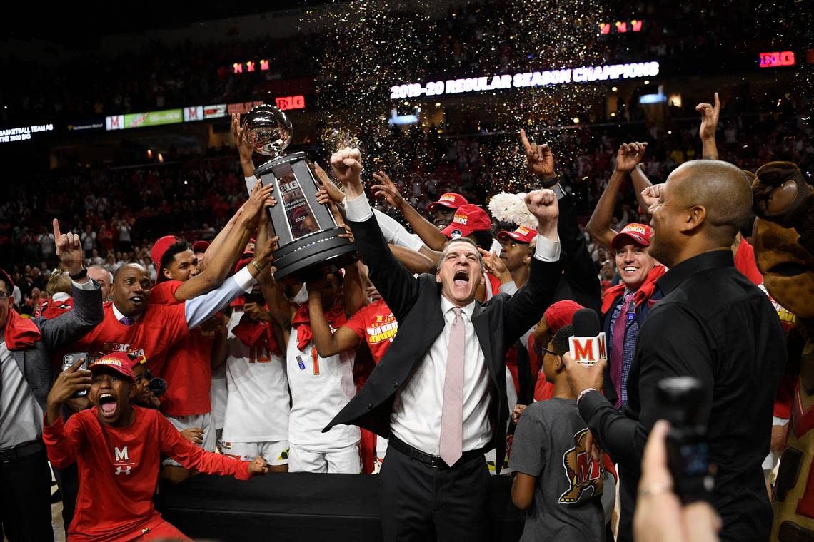 Maryland head coach Mark Turgeon, right center, and his team celebrate after they won a share of the Big Ten regular season title after defeating Michigan in an NCAA college basketball game, Sunday, March 8, 2020, in College Park, Md. Maryland won 83-70. (AP Photo/Nick Wass)