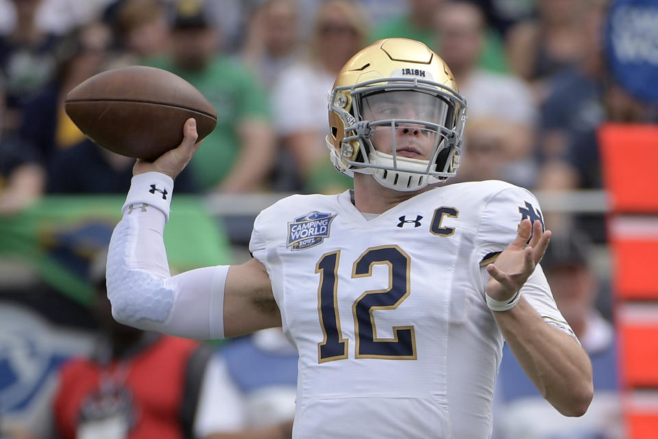 Notre Dame quarterback Ian Book (12) throws a pass during the first half of the Camping World Bowl NCAA college football game against Iowa State Saturday, Dec. 28, 2019, in Orlando, Fla. (AP Photo/Phelan M. Ebenhack)