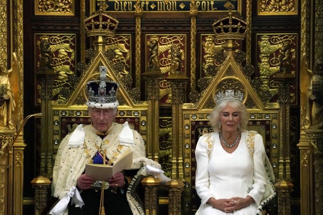 Charles sitting next to Camilla as he reads the King's Speech