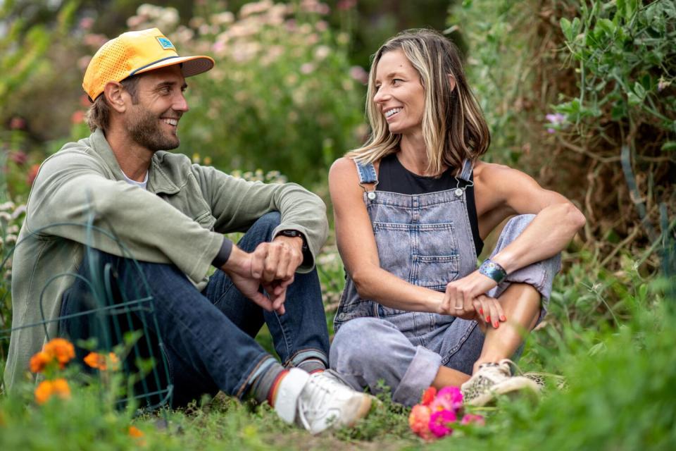 Chad and Stacie Vanags sit in their flower garden.