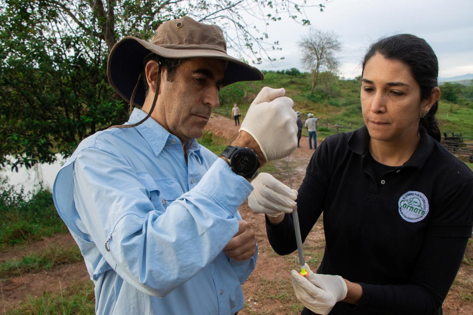 Cornare and USDA APHIS experts prepare a dart with the drug GonaCon, used for immunocastration of animals, before using it on hippos to control the expansion of their population, in Puerto Triunfo, Colombia October 8, 2021. Picture taken October 8, 2021. Courtesy of Regional Autonomous Corporation of the Negro and Nare River Basins (CORNARE)/Handout via REUTERS ATTENTION EDITORS - THIS IMAGE WAS PROVIDED BY A THIRD PARTY.