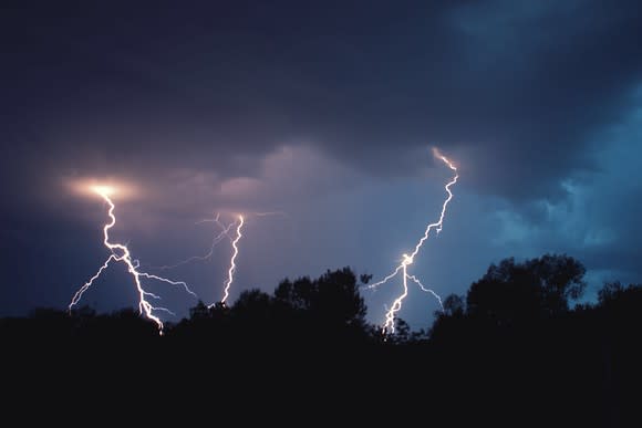 Three lightning bolts at night