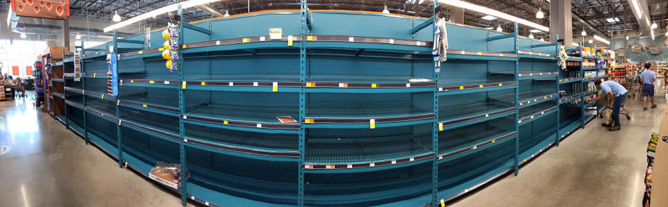 In this panoramic view, empty shelves show the depleted supply of bottled water at the Whole Foods store in Winter Park, Florida, as residents prepare.&nbsp;