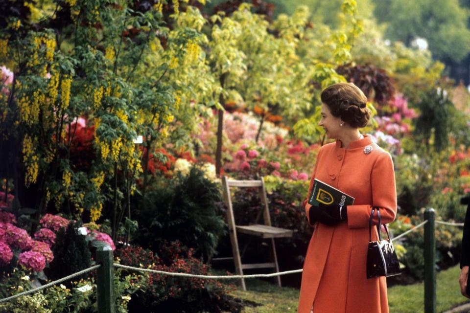 <p>Her Majesty visited the Chelsea Flower Show in a beautiful orange coat.<br><i>[Photo: PA]</i> </p>