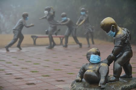 Masks are pictured on sculptures in a park during a hazy day in Puyang, Henan province, China January 4, 2017. Picture taken January 4, 2017. REUTERS/Stringer