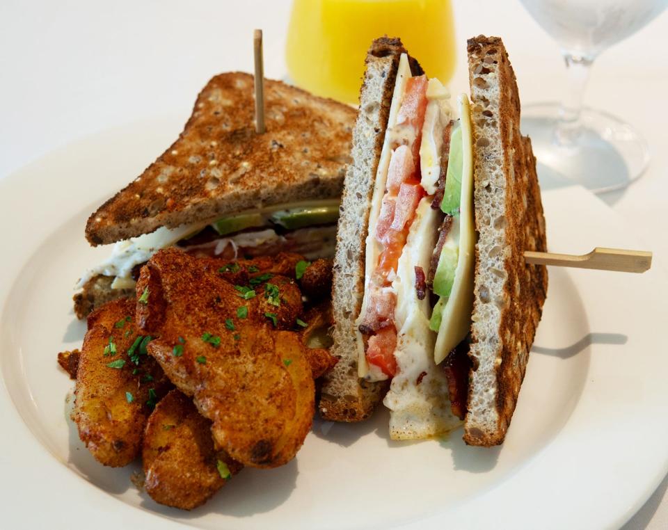 The Palm Beach Club sandwich, served with seasoned French fries, at Polpo at Eau Palm Beach Resort.