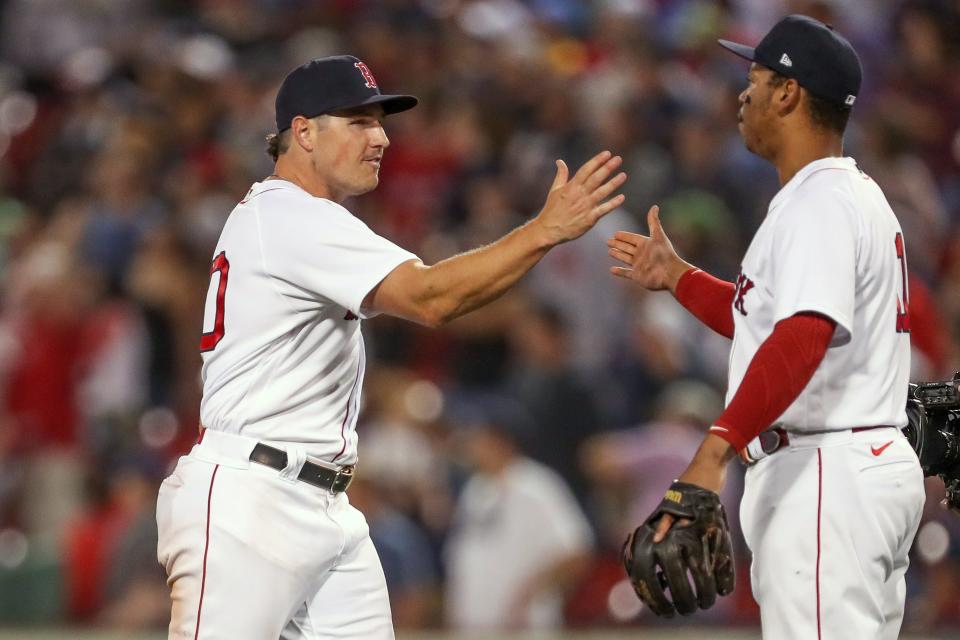 Red Sox outfielder Hunter Renfroe, left, and third baseman Rafael Devers celebrate Wednesday's win over Tampa Bay Rays that moved Boston into the AL's top wild-card playoff spot.