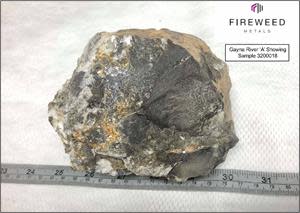 Figure 5: Gayna River ‘A’ showing, sample 3200018. Upper-Host sub-rounded dolostone breccia, matrix infilled with dolomite, calcite, crystalline red and green sphalerite, and metallic galena.